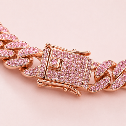 Rose gold chain bracelet with pink gemstones on a light pink background